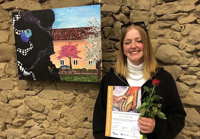 Lea Salzwedel vor ihrer Arbeit, mit der sie den MaWi-Kunstförderpreis 2022 gewonnen hatte. Foto: Stadt Bischofswerda