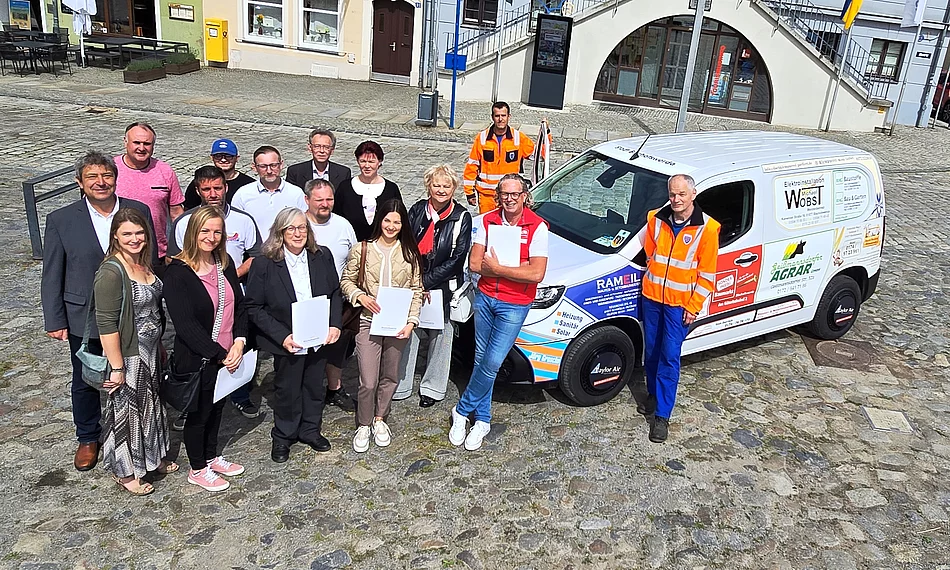 Oberbürgermeister Holm Große (links) und Hausmeister Thomas Petzold (rechts) bedankten sich bei den anwesenden Sponsoren für das neue Bauhof-Fahrzeug.